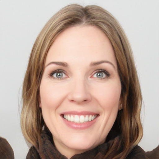 Joyful white young-adult female with medium  brown hair and blue eyes