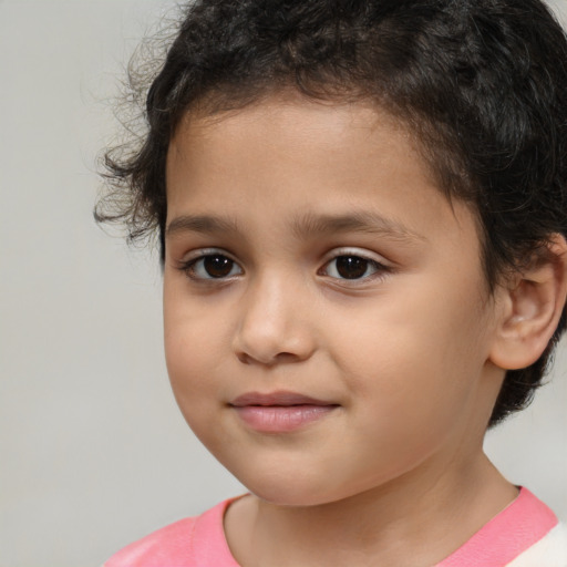 Joyful white child male with medium  brown hair and brown eyes