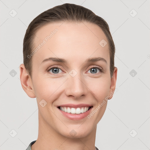 Joyful white young-adult female with short  brown hair and grey eyes