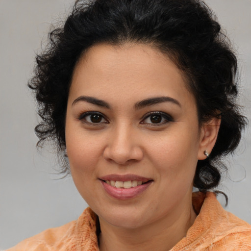 Joyful latino young-adult female with medium  brown hair and brown eyes