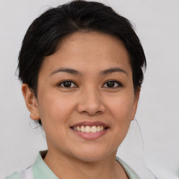 Joyful asian young-adult female with short  brown hair and brown eyes