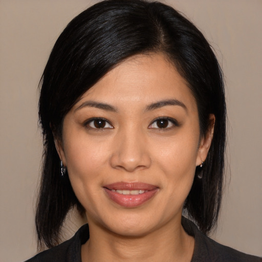 Joyful asian young-adult female with medium  black hair and brown eyes