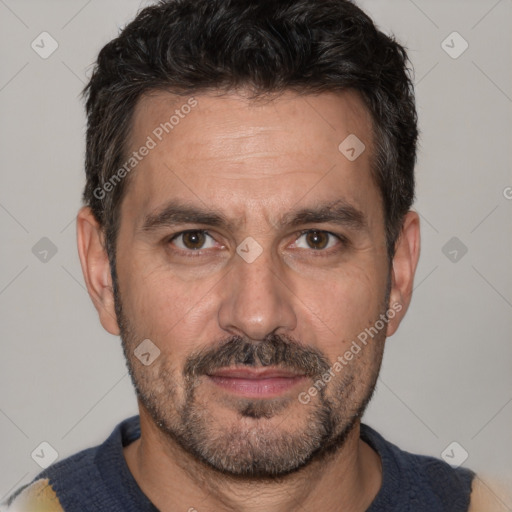 Joyful white adult male with short  black hair and brown eyes