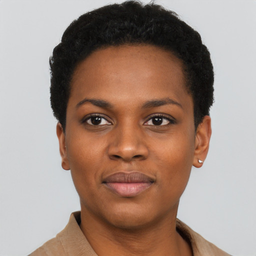 Joyful black young-adult female with short  black hair and brown eyes