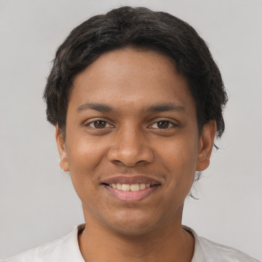 Joyful latino young-adult male with short  brown hair and brown eyes