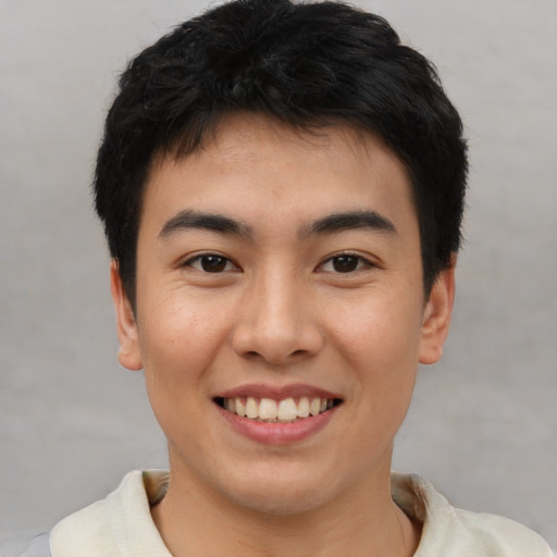 Joyful asian young-adult male with short  black hair and brown eyes