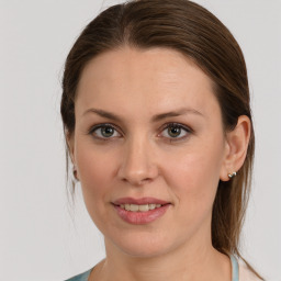 Joyful white young-adult female with medium  brown hair and grey eyes