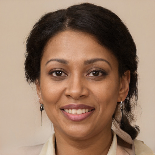 Joyful black adult female with medium  brown hair and brown eyes