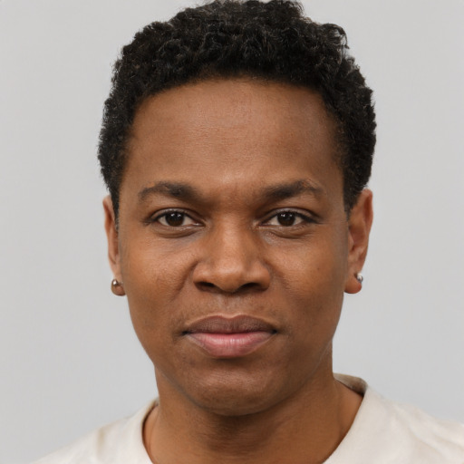 Joyful black adult male with short  black hair and brown eyes