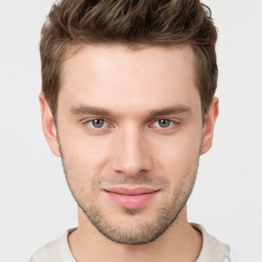 Joyful white young-adult male with short  brown hair and grey eyes