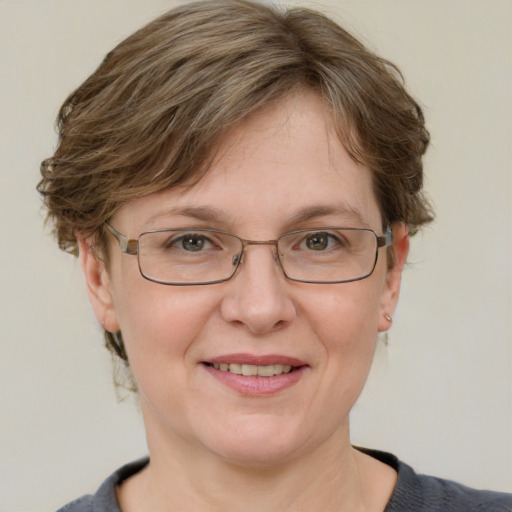 Joyful white adult female with short  brown hair and blue eyes