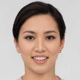 Joyful asian young-adult female with medium  brown hair and brown eyes