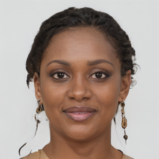 Joyful black young-adult female with long  brown hair and brown eyes