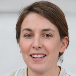 Joyful white adult female with medium  brown hair and grey eyes