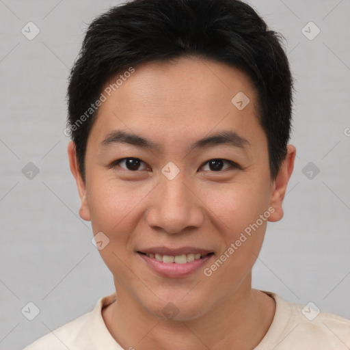 Joyful asian young-adult male with short  brown hair and brown eyes