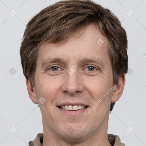 Joyful white adult male with short  brown hair and grey eyes