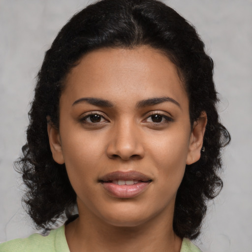 Joyful latino young-adult female with medium  black hair and brown eyes