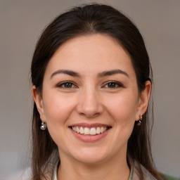 Joyful white young-adult female with medium  brown hair and brown eyes