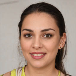 Joyful white young-adult female with medium  brown hair and brown eyes