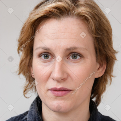 Joyful white adult female with medium  brown hair and blue eyes