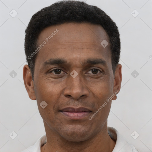 Joyful black adult male with short  black hair and brown eyes