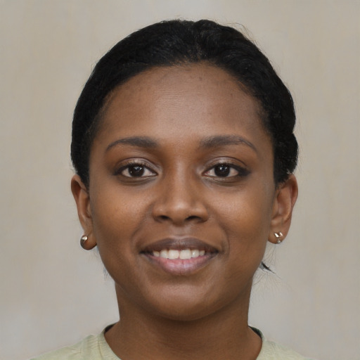 Joyful black young-adult female with short  black hair and brown eyes