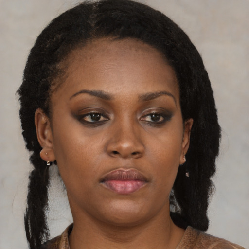 Neutral black young-adult female with medium  brown hair and brown eyes