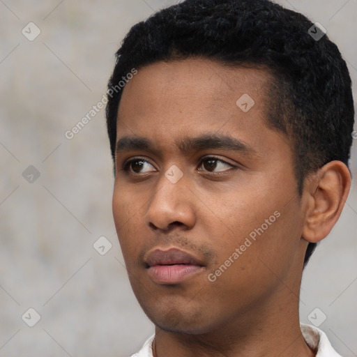 Neutral latino young-adult male with short  black hair and brown eyes