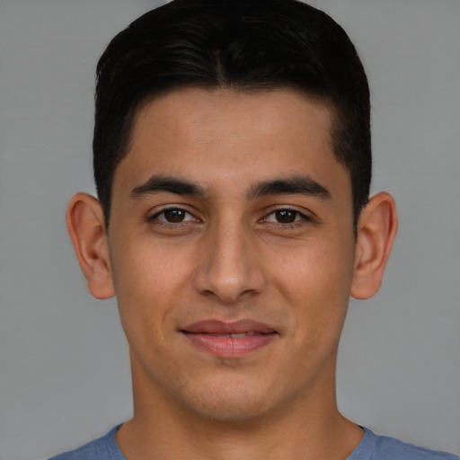 Joyful latino young-adult male with short  brown hair and brown eyes