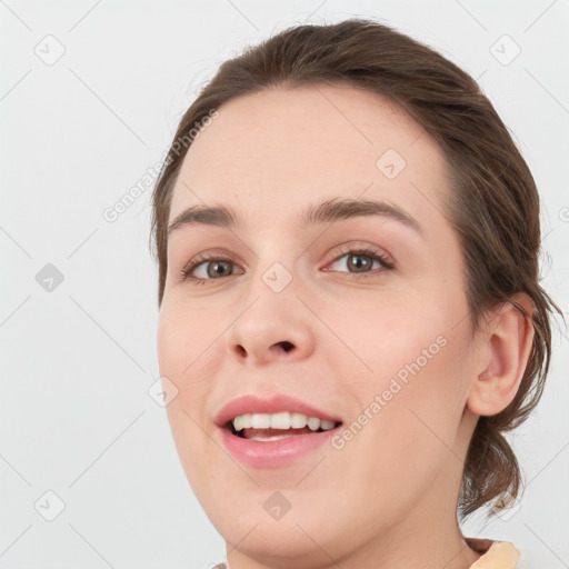 Joyful white young-adult female with medium  brown hair and green eyes