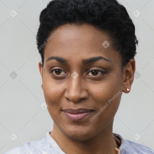 Joyful black young-adult female with short  black hair and brown eyes