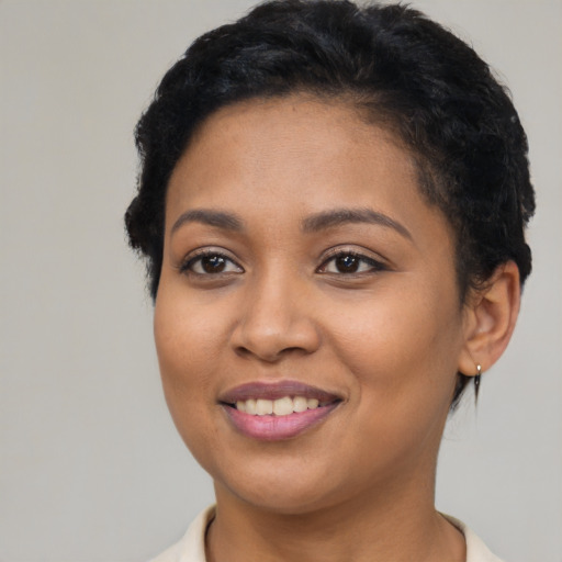 Joyful latino young-adult female with short  black hair and brown eyes