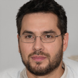 Joyful white adult male with short  brown hair and brown eyes