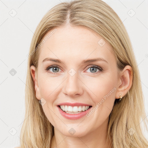 Joyful white young-adult female with long  brown hair and blue eyes