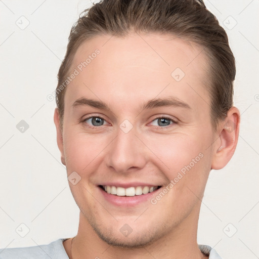 Joyful white young-adult female with short  brown hair and grey eyes