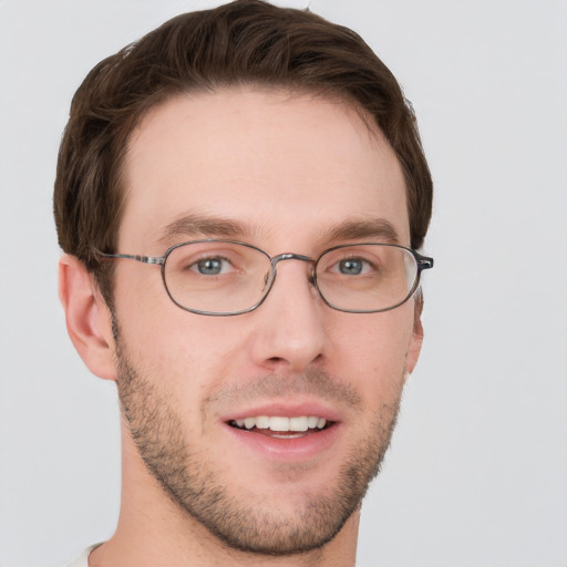 Joyful white young-adult male with short  brown hair and grey eyes