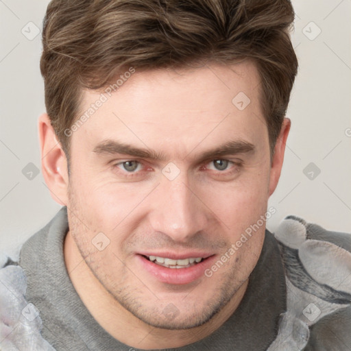 Joyful white adult male with short  brown hair and grey eyes