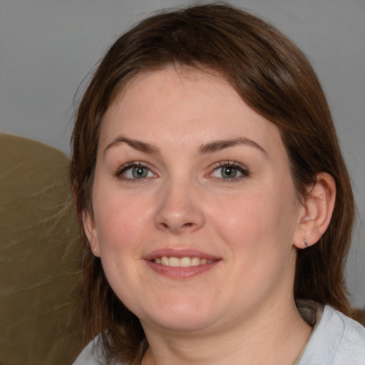 Joyful white young-adult female with medium  brown hair and blue eyes