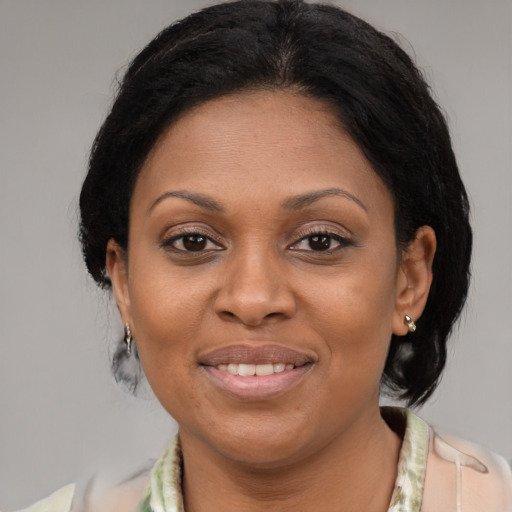 Joyful latino adult female with medium  brown hair and brown eyes