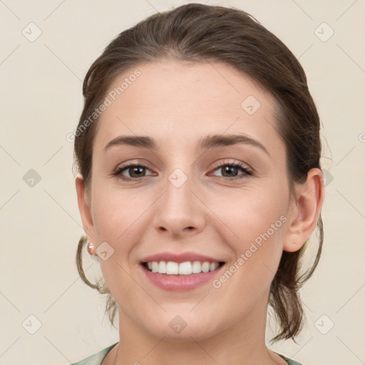 Joyful white young-adult female with medium  brown hair and grey eyes