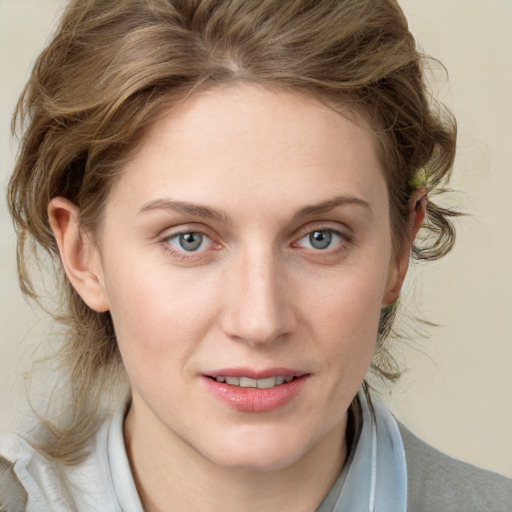 Joyful white young-adult female with medium  brown hair and blue eyes