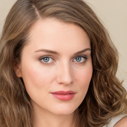 Joyful white young-adult female with long  brown hair and green eyes