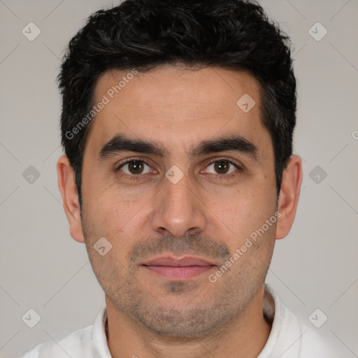 Joyful white young-adult male with short  black hair and brown eyes