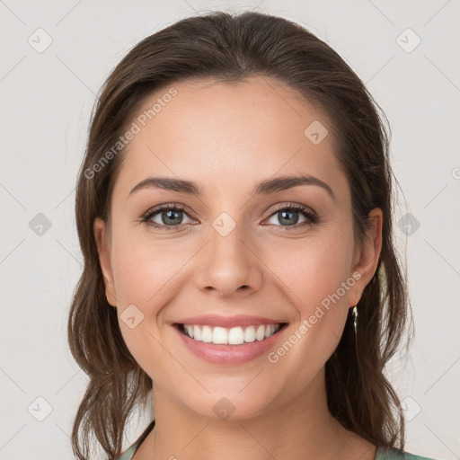 Joyful white young-adult female with medium  brown hair and grey eyes