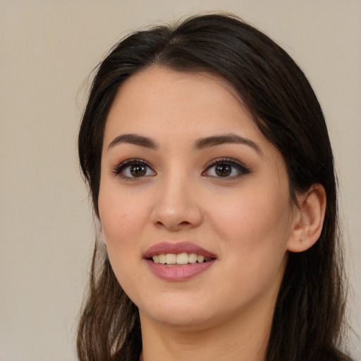 Joyful latino young-adult female with long  brown hair and brown eyes