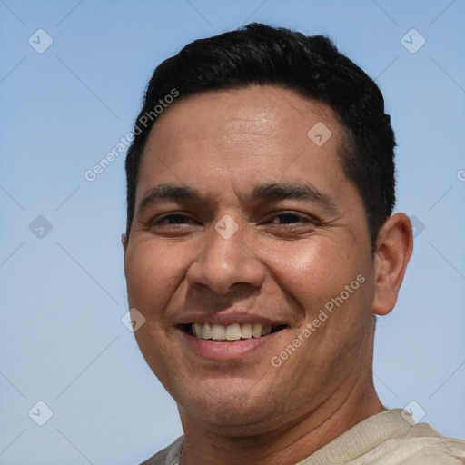 Joyful white adult male with short  black hair and brown eyes