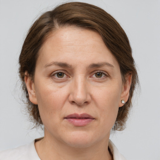 Joyful white adult female with medium  brown hair and grey eyes