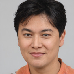 Joyful asian young-adult male with short  brown hair and brown eyes