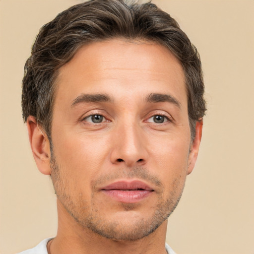 Joyful white adult male with short  brown hair and brown eyes