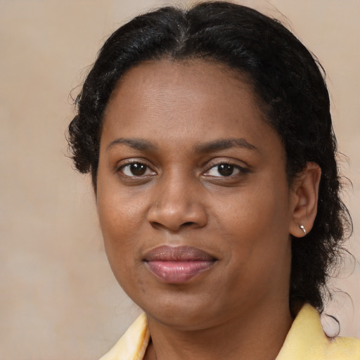 Joyful black young-adult female with medium  brown hair and brown eyes
